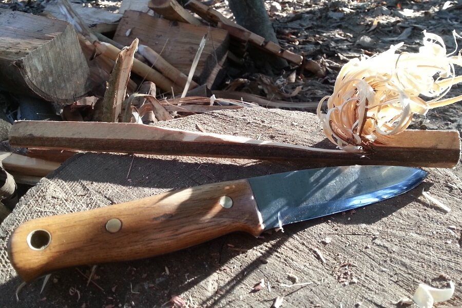 A classic Bushcraft knife (blade by Steve Wade Cox) with feather sticks