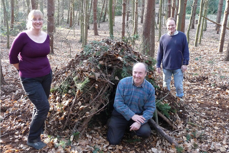 Youth leaders build a natural shelter